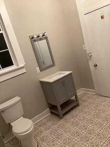 bathroom featuring vanity and toilet