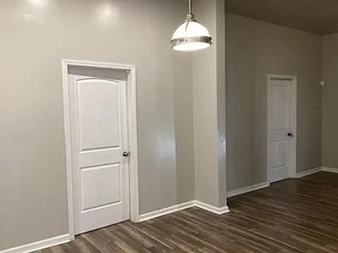 empty room with dark wood-type flooring