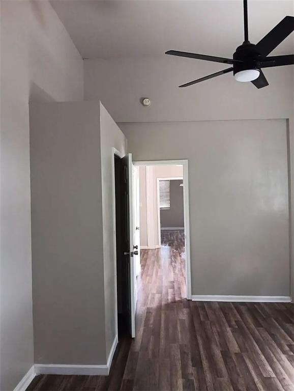 hallway with dark hardwood / wood-style floors