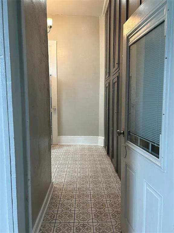 corridor with tile patterned flooring