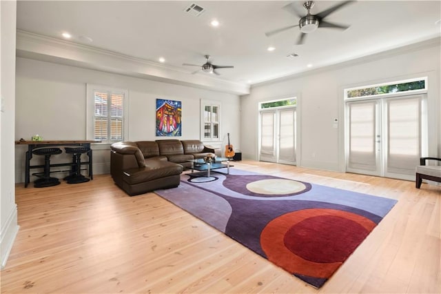 living room featuring light hardwood / wood-style floors, ceiling fan, and a wealth of natural light