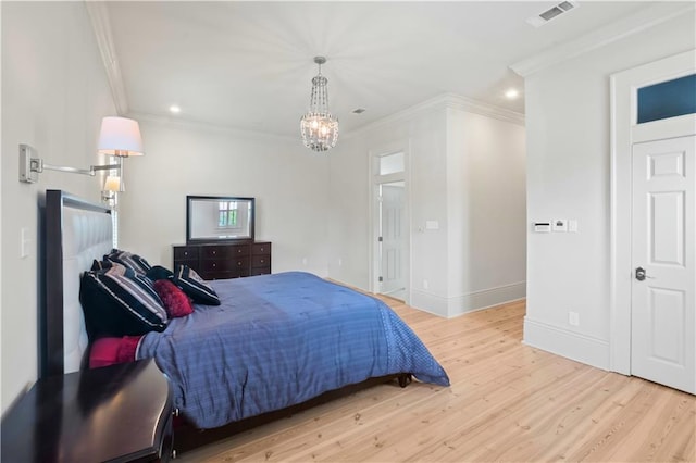 bedroom featuring light hardwood / wood-style flooring, a chandelier, and ornamental molding