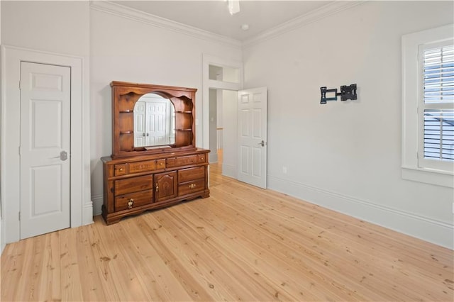 bedroom with light hardwood / wood-style flooring and crown molding