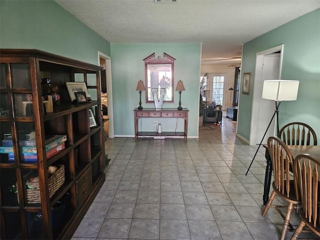 sitting room with a textured ceiling and tile patterned floors