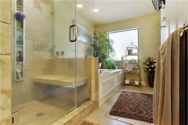 bathroom with a shower with door and tile patterned floors