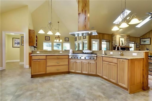 kitchen with high vaulted ceiling, stainless steel gas cooktop, hanging light fixtures, and sink