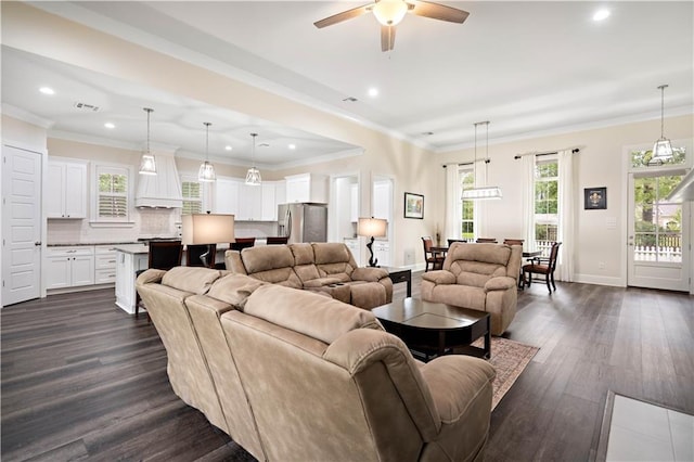 living room with ceiling fan, ornamental molding, and dark hardwood / wood-style flooring