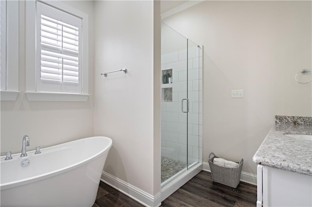 bathroom with vanity, separate shower and tub, and hardwood / wood-style flooring