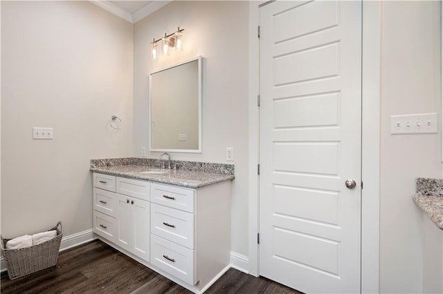 bathroom with wood-type flooring, vanity, and crown molding