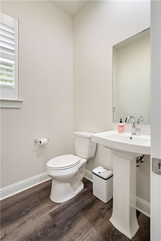 bathroom with wood-type flooring and toilet