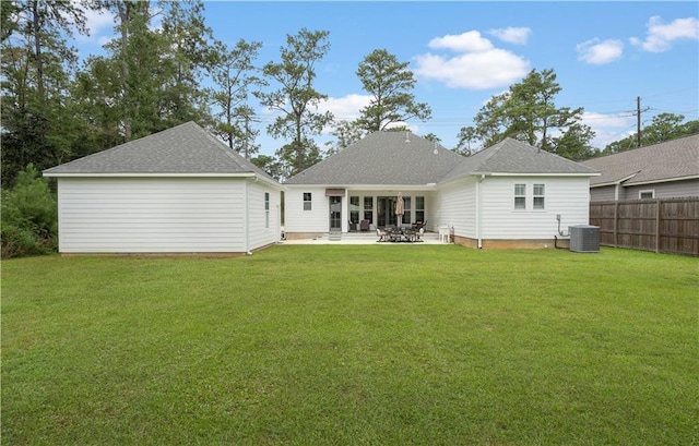 rear view of property featuring a patio, cooling unit, and a lawn