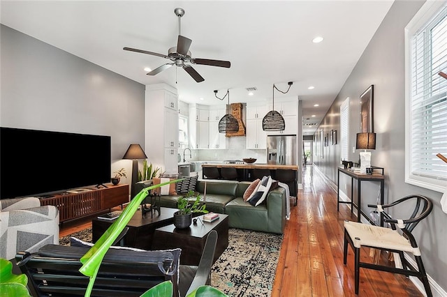 living room with hardwood / wood-style flooring, ceiling fan, and plenty of natural light