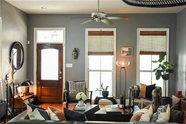 living room featuring ceiling fan and hardwood / wood-style floors