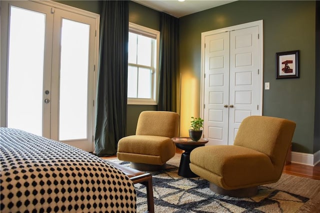 living area with wood-type flooring and french doors