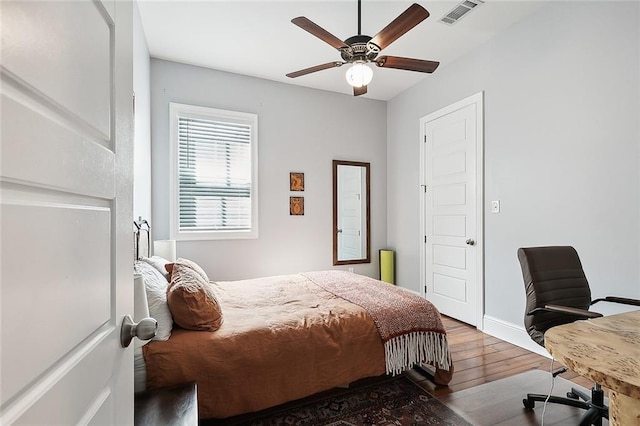 bedroom with ceiling fan and hardwood / wood-style floors