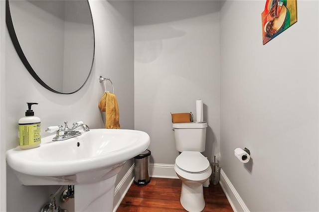 bathroom with wood-type flooring and toilet