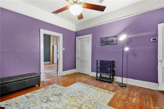 interior space featuring hardwood / wood-style floors and ceiling fan