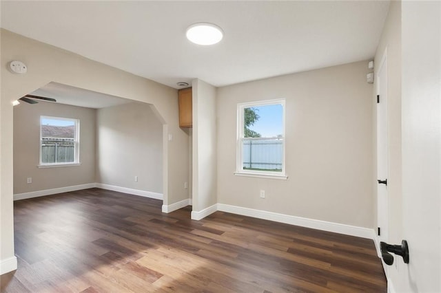 empty room featuring dark hardwood / wood-style flooring and a healthy amount of sunlight