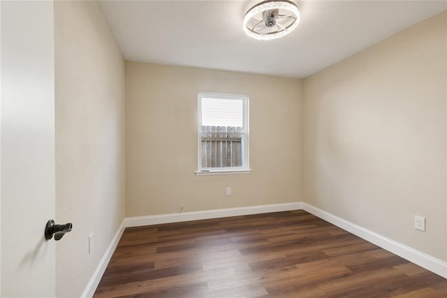 spare room with dark hardwood / wood-style floors