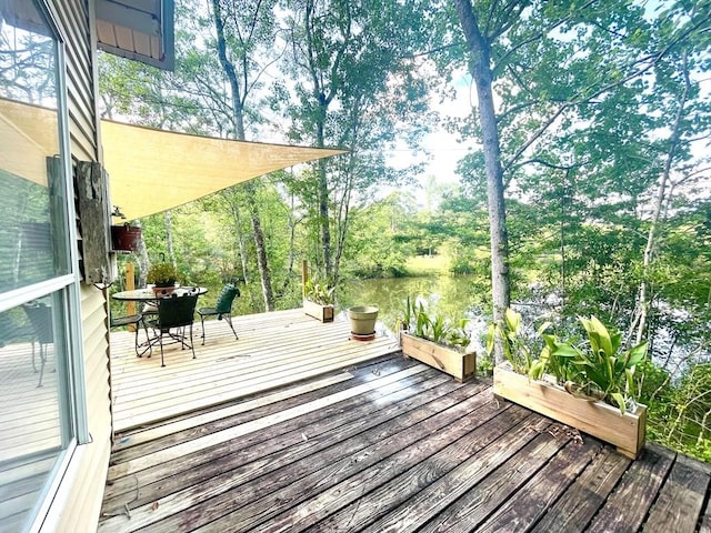 wooden terrace featuring a water view