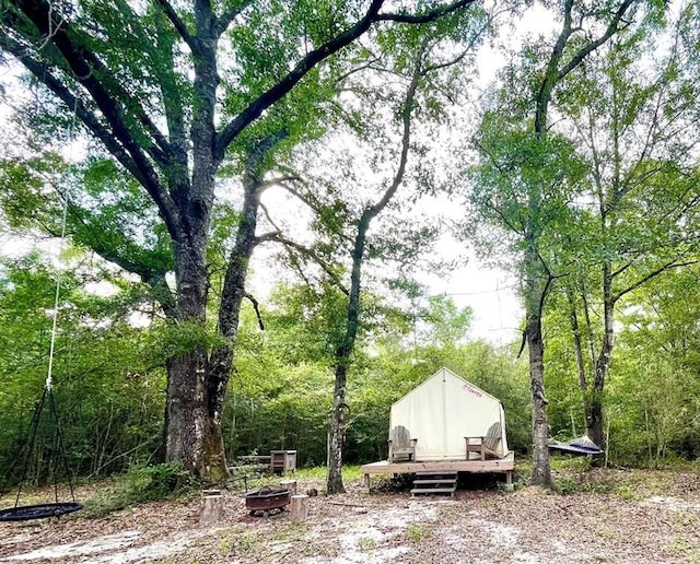 exterior space with a shed and an outdoor fire pit