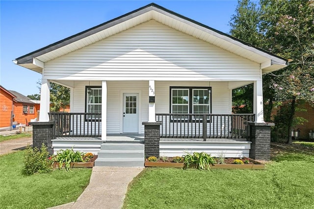 bungalow-style house with a porch and a front lawn