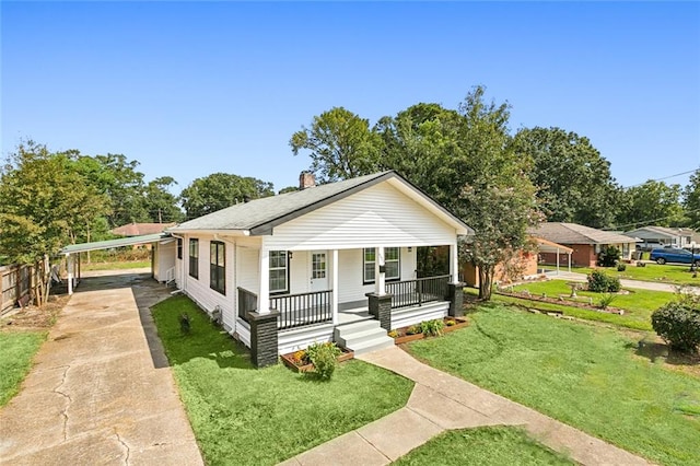 bungalow-style house with a front yard, covered porch, and a carport