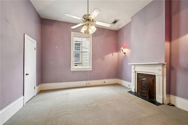 unfurnished living room featuring ceiling fan and light carpet