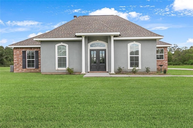 rear view of property featuring central AC, french doors, and a yard