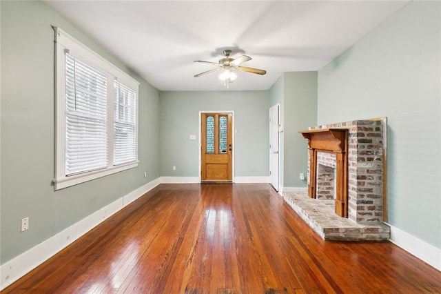 unfurnished living room with wood-type flooring, a fireplace, and ceiling fan