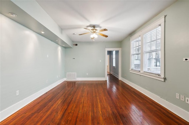 spare room with dark wood-type flooring and ceiling fan