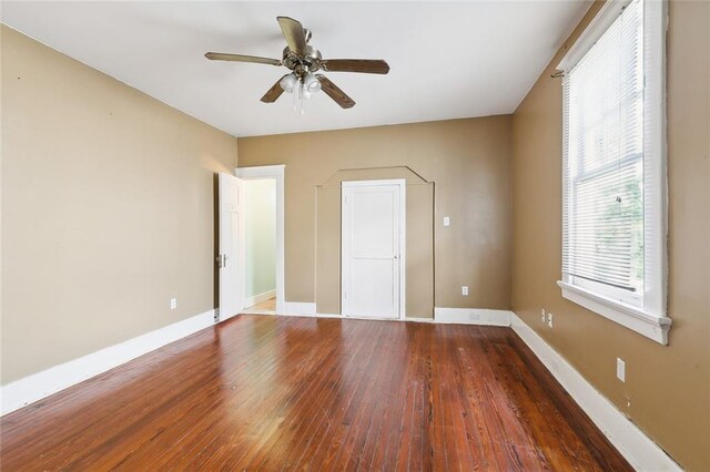 unfurnished bedroom with dark wood-type flooring and ceiling fan