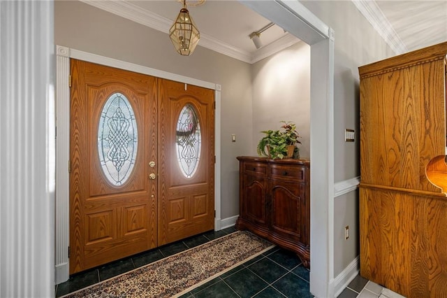 entryway with ornamental molding and dark tile patterned floors