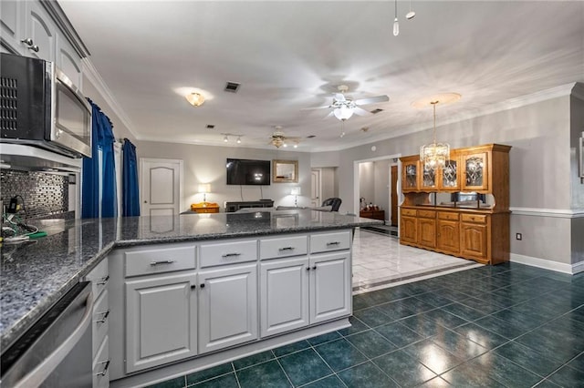 kitchen featuring backsplash, white cabinetry, stainless steel appliances, ceiling fan with notable chandelier, and crown molding