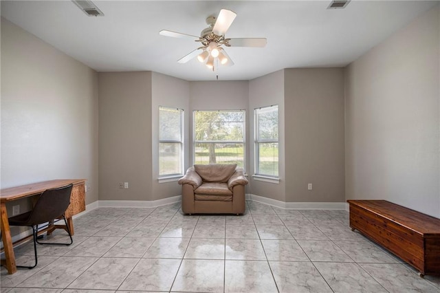 living area featuring ceiling fan and light tile patterned floors