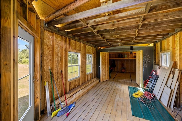 unfurnished sunroom featuring vaulted ceiling