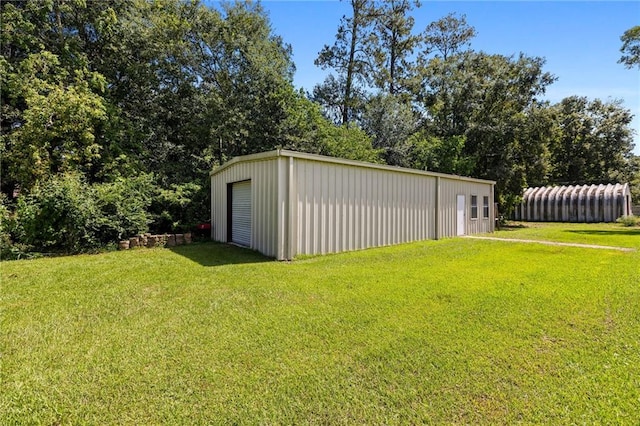 view of outbuilding with a lawn and a garage