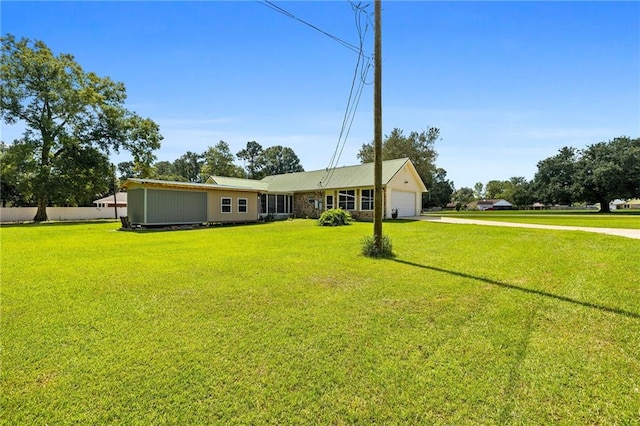 exterior space featuring a front lawn and a garage