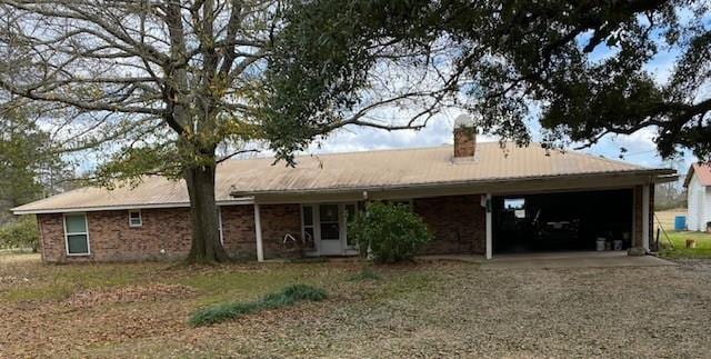 rear view of house featuring a garage