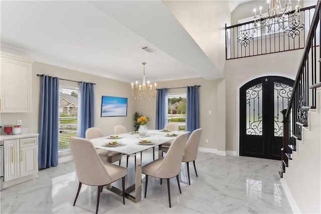 dining room with french doors, a notable chandelier, and a wealth of natural light