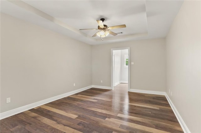 spare room featuring ceiling fan and dark hardwood / wood-style floors