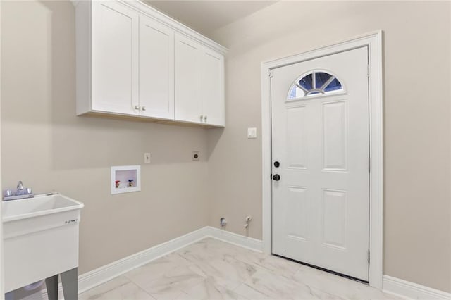 clothes washing area featuring washer hookup, hookup for an electric dryer, cabinets, sink, and gas dryer hookup