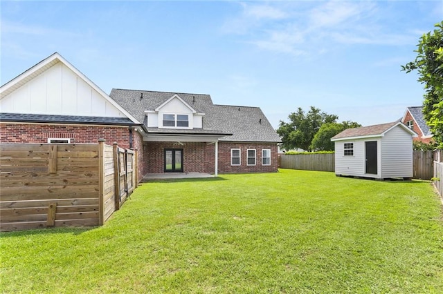 rear view of house featuring a storage shed and a lawn