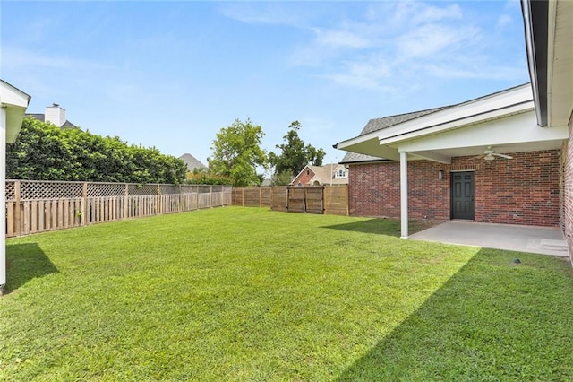 view of yard featuring ceiling fan and a patio area