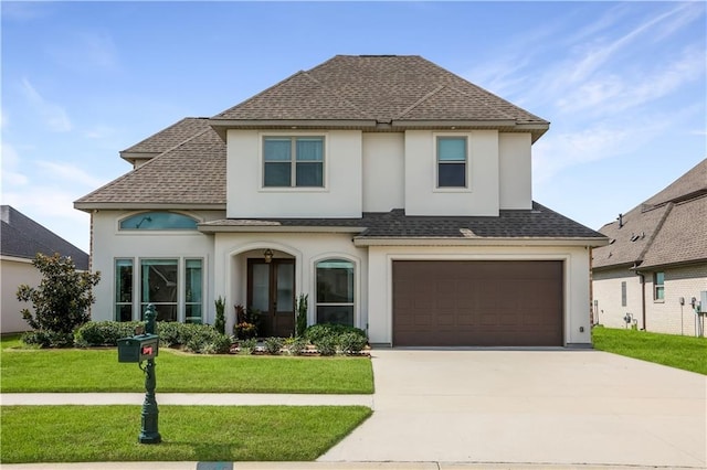 view of front of property featuring a garage and a front lawn