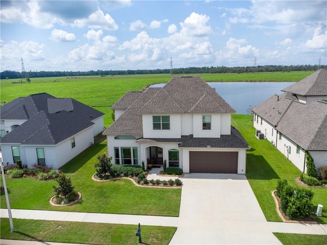 view of front of house with a water view, a garage, and a front yard