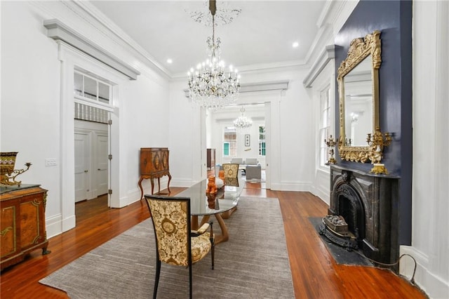 dining area with ornamental molding, dark hardwood / wood-style flooring, and a chandelier