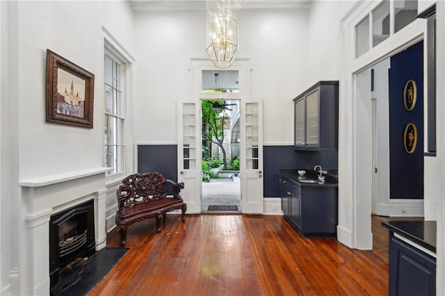 interior space with sink, dark hardwood / wood-style floors, a chandelier, and a wealth of natural light