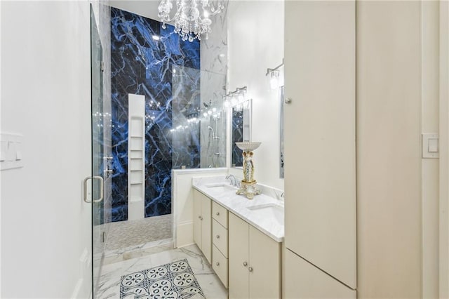 bathroom featuring a shower with door and vanity