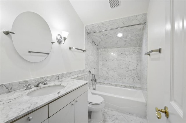 full bathroom featuring tiled shower / bath combo, vanity, and toilet